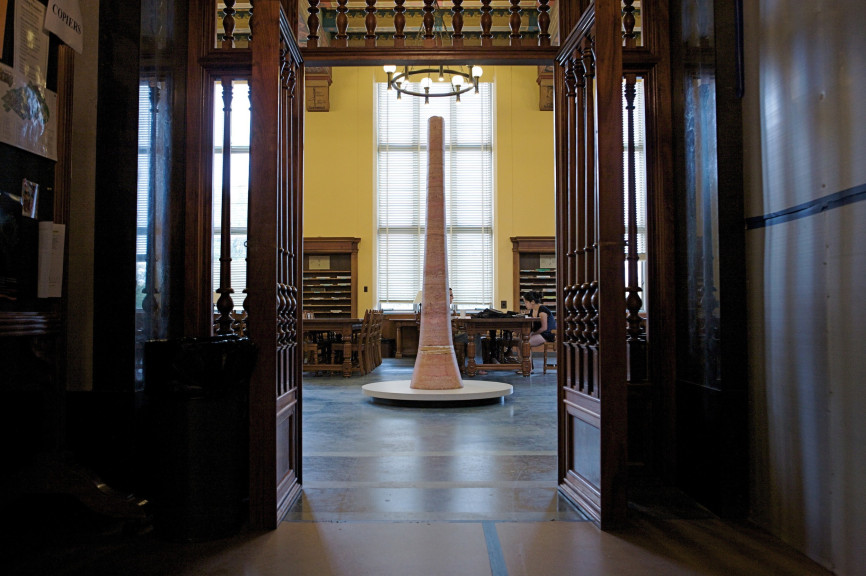 A marble sculpture in the doorway of a large room