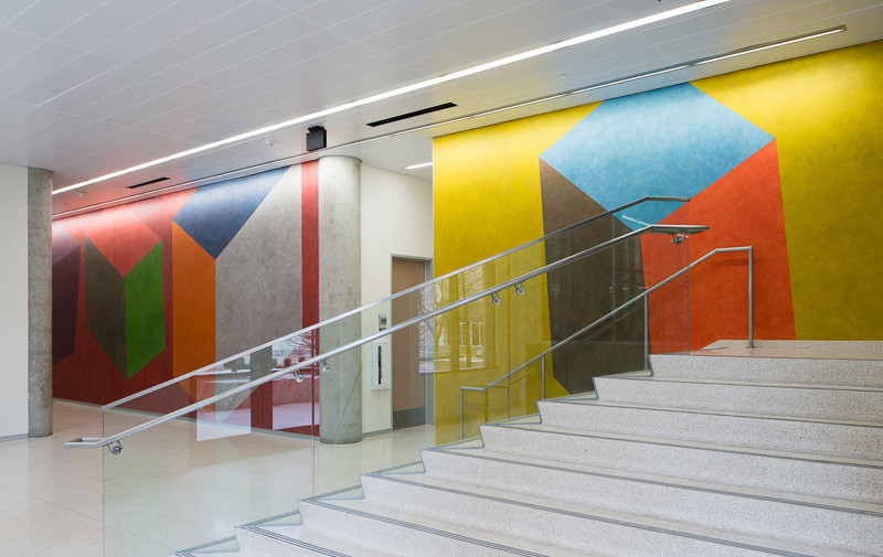 A wall drawing in front of a stairwell