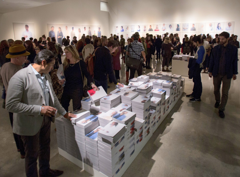 crowd in space around stack of books