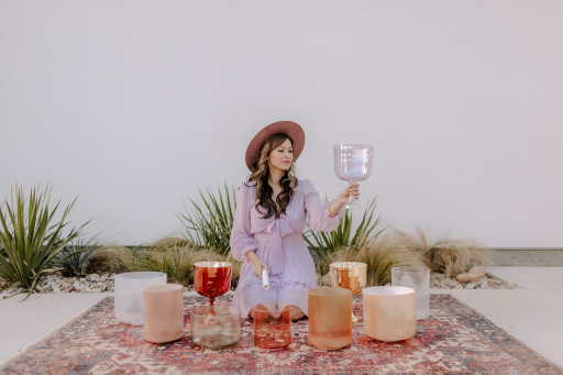 An image of Sonic Starchild (Jen Vu) in a landscape surrounded by sound bowls.