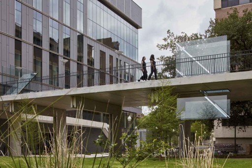 A photo of Sarah Oppenheimer's "C-010106" a work made of glass which cuts through a pedestrian footbridge.